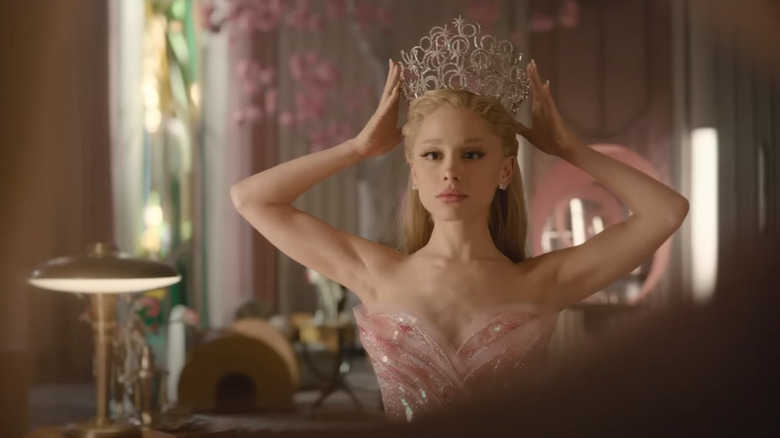 Glinda fitting her crown upon her head in Wicked: For Good