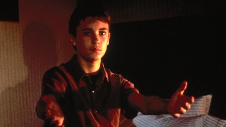 Wil Wheaton reaches out from his bed as Zack Crane in The Curse