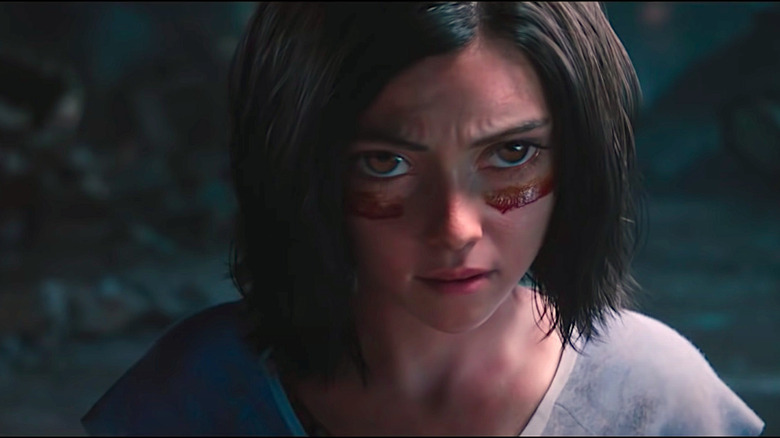 Alita Looks On With Battle Paint On Her Face