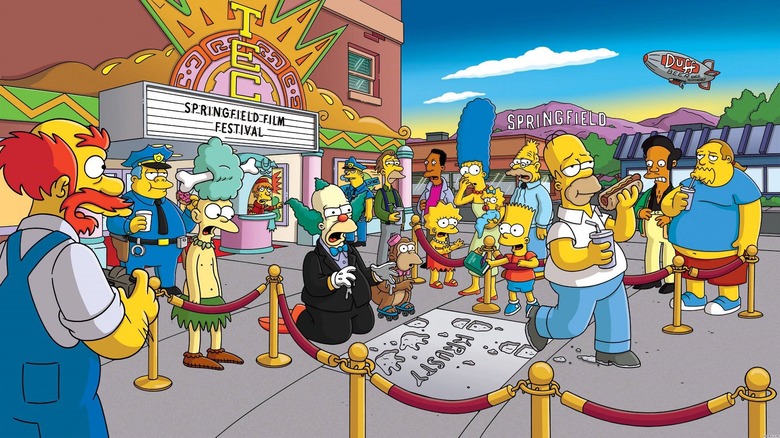 Homer Simpson ruining Krusty the Clown's handprint ceremony in front of a theater