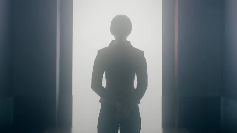 Yeoman Colt stands silhouetted in front of opening doors in the 765874 Star Trek short