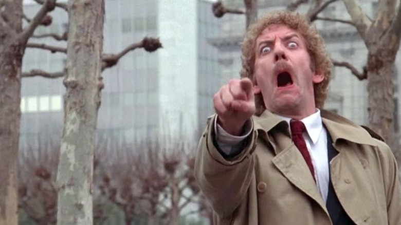 Donald Sutherland lifts his finger and shrieks as the pod person version of Matthew Bennell in Invasion of the Body Snatchers