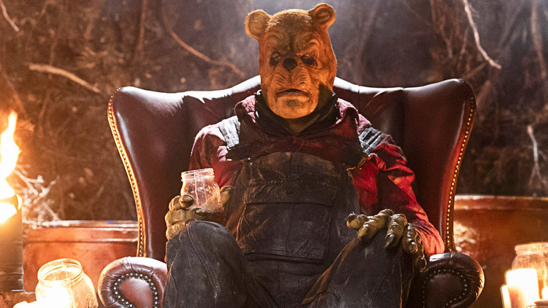 Winnie the Pooh sitting on his chair drinking honey in Winnie the Pooh: Bloody and Honey 2