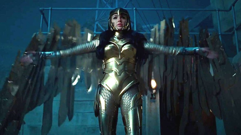 Gal Gadot as Wonder Woman in her gold suit with her arms out in Wonder Woman 1984