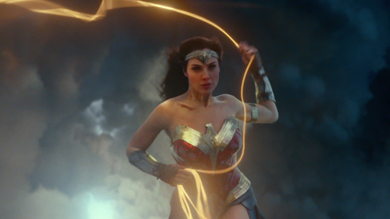 Gal Gadot as Wonder Woman swinging her lasso in the sky in Wonder Woman 1984