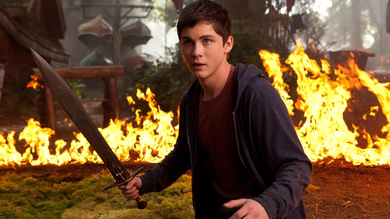 Logan Lerman's Percy Jackson wields a sword against his horrific comp job fiery background in Percy Jackson: Sea of Monsters