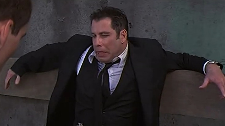 Sean Archer (Nic Cage) pointing a speargun at Castor Troy (John Travolta) in Face/Off