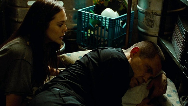 Joe resting on a pillow while Marie watches in 2013's Oldboy