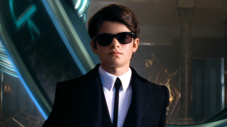 Artemis Fowl (Ferdia Shaw) struts in a suit in Artemis Fowl