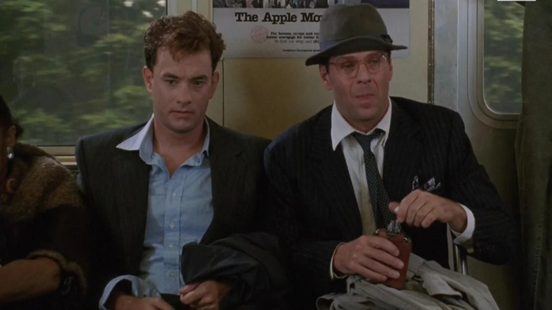 Sherman McCoy (Tom Hanks) and Peter Fallow (Bruce Willis) are drunk on the subway in The Bonfire of the Vanities