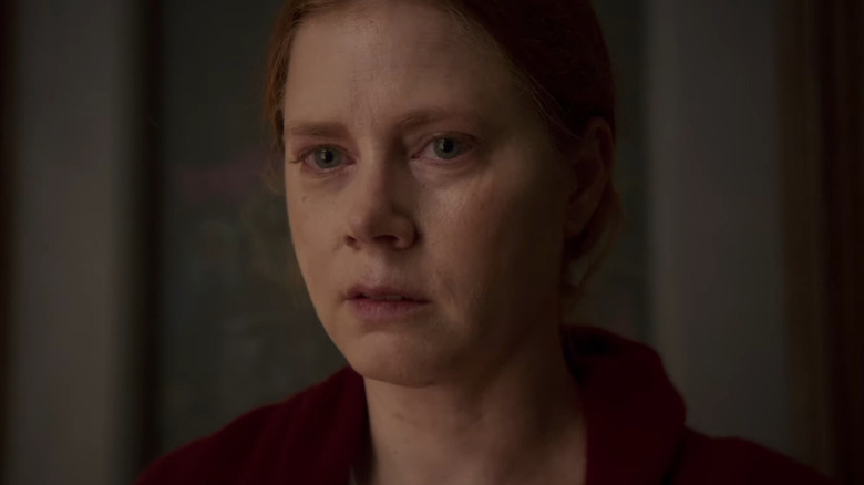 Dr. Anna Fox (Amy Adams) is depressed and worried in The Woman in the Window