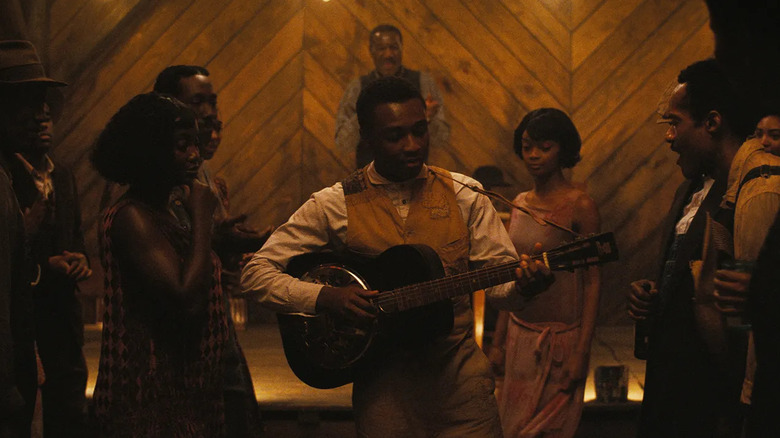 Sammie Moore (Miles Caton) playing guitar in Sinners