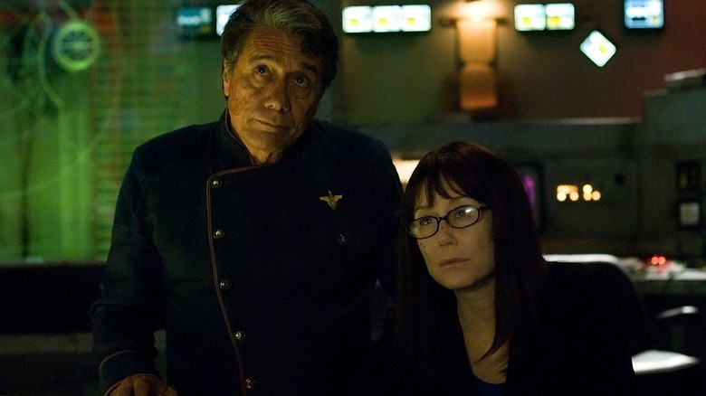 William Adama (Edward James Olmos) and Laura Roslin (Mary McDonnell) sit in a control room in Battlestar Galactica (2003)
