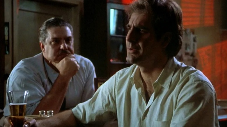 Al (Bruce McGill) watches Sam Beckett (Scott Bakula) intently at a bar in Quantum Leap (1989)