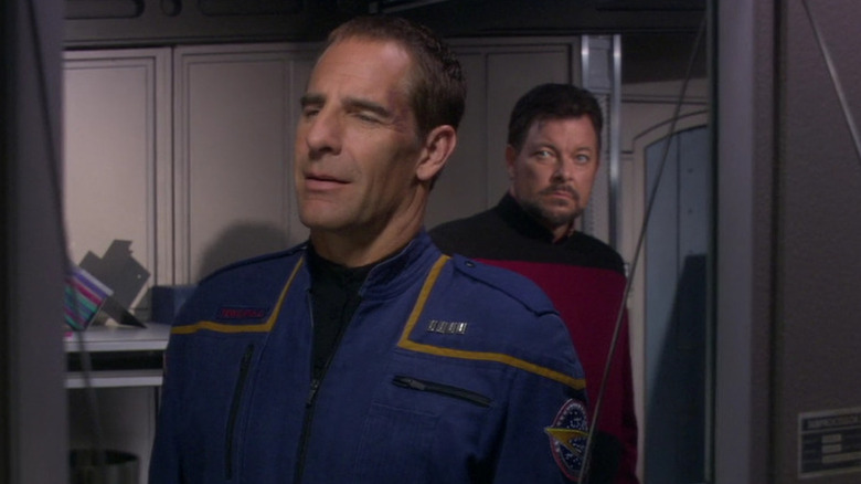 Will Riker (Jonathan Frakes) stares at an oblivious Jonathan Archer (Scott Bakula) in Star Trek: Enterprise
