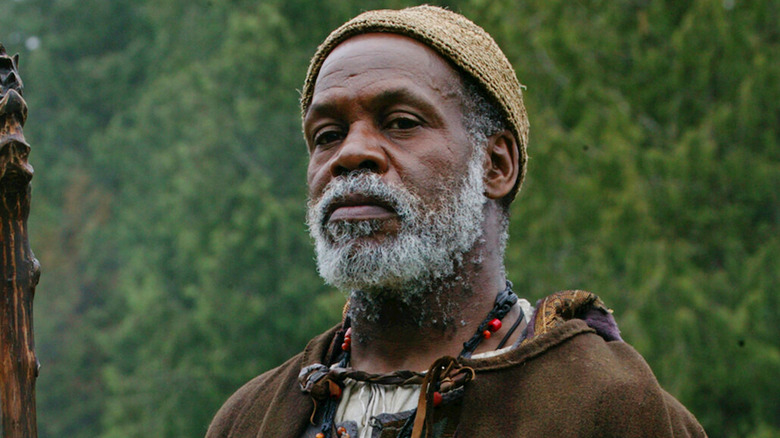 Danny Glover as Ogion holding his staff in Earthsea