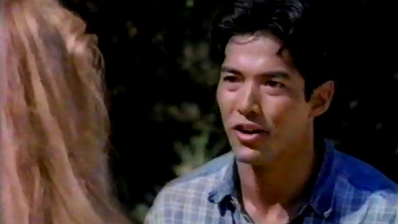 Jian-Wa Chang talking to a woman in Vanishing Son