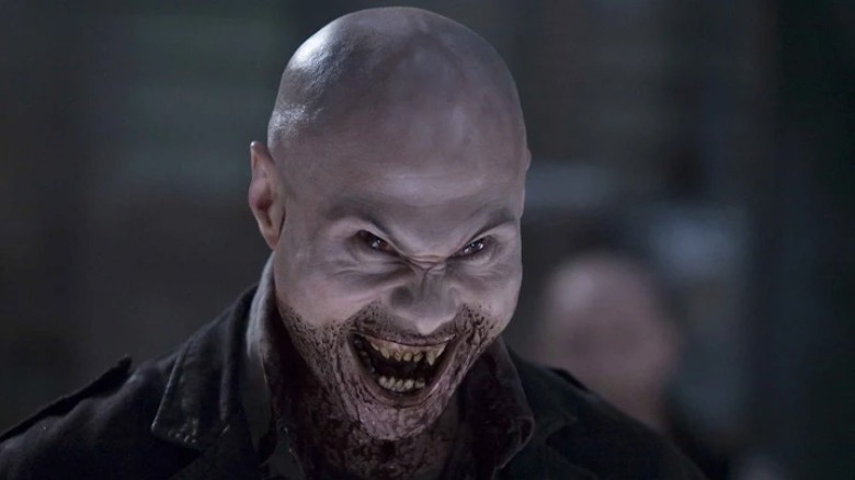 Vampire teeth bared, bloody