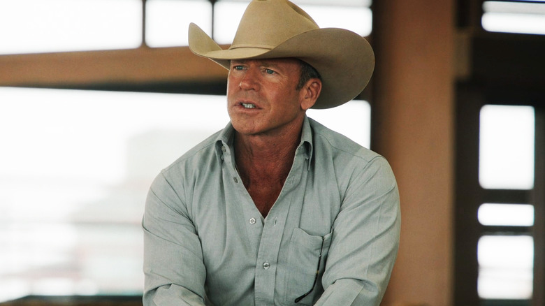 Taylor Sheridan while Travis Witti looks through the frame sitting on a horse in Yellowston