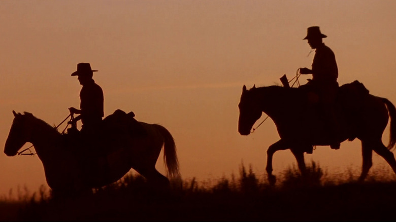 The silhouettes of two cowboys on horseback in Unforgiven