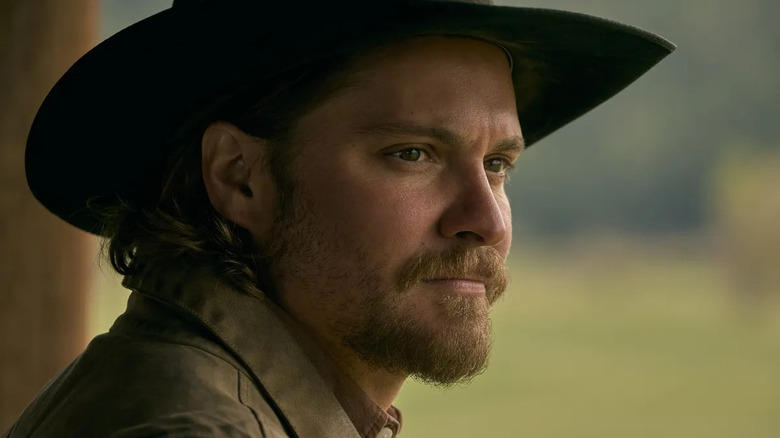 Luke Grimes as Kayce, staring into the distance on Yellowstone