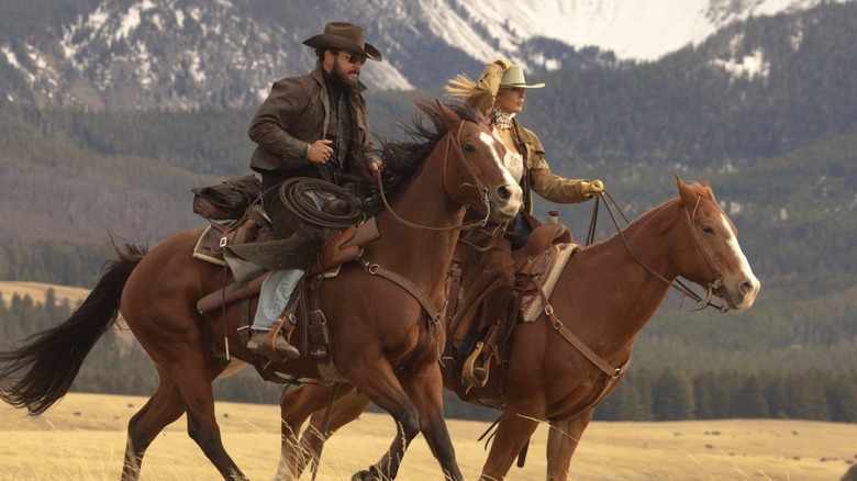 Cole Houser as Rip Wheeler and Kelly Reilly as Beth Dutton riding horses in Dutton Ranch
