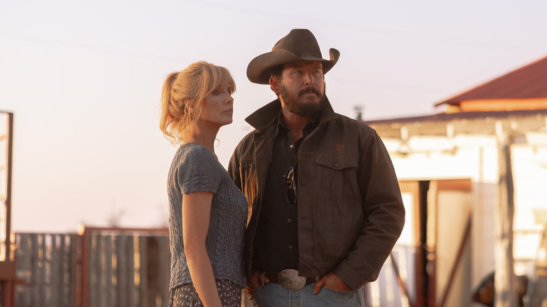 Cole Hauser's Rip Wheeler and Kelly Reilly's Beth Dutton stand side by side outside their ranch home in Dutton Ranch