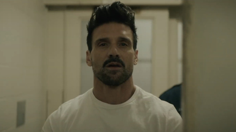 Frank Grillo's Sloan stands in a white prison room in Into the Ashes