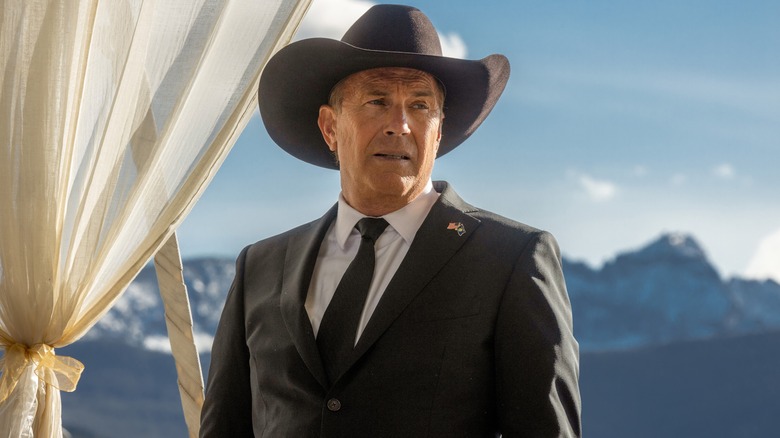 Kevin Costner's John Dutton in a black cowboy hat and suit in Yellowstone