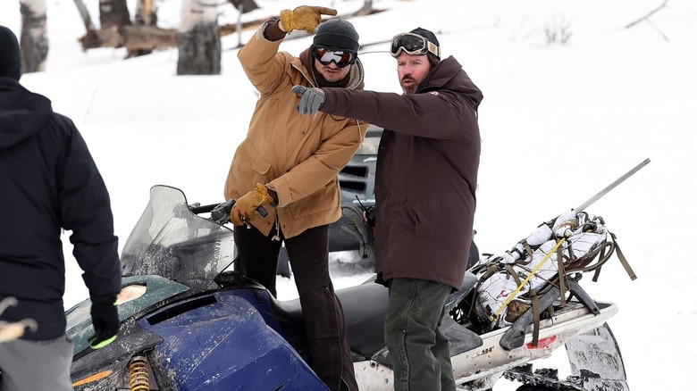 Taylor Sheridan and Jeremy Renner pointing in opposite directions on the Wind River set