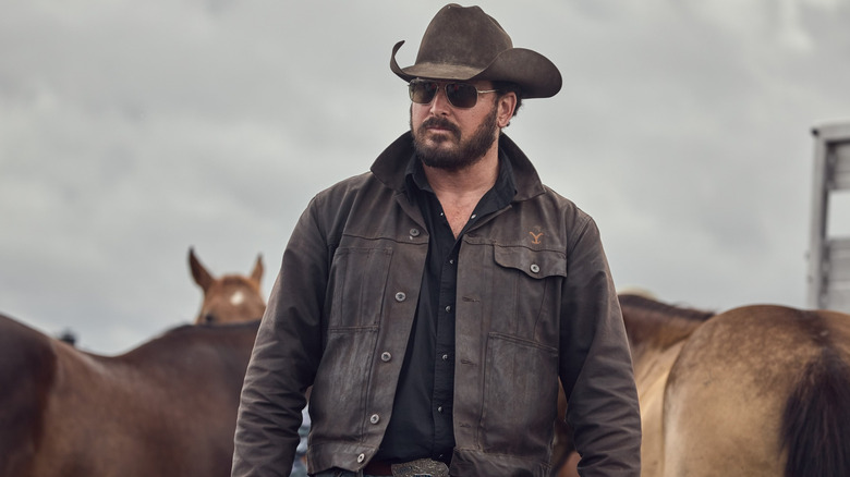 Cole Hauser as Rip Wheeler standing in front of horses in the Yellowstone episode Meaner Than Evil