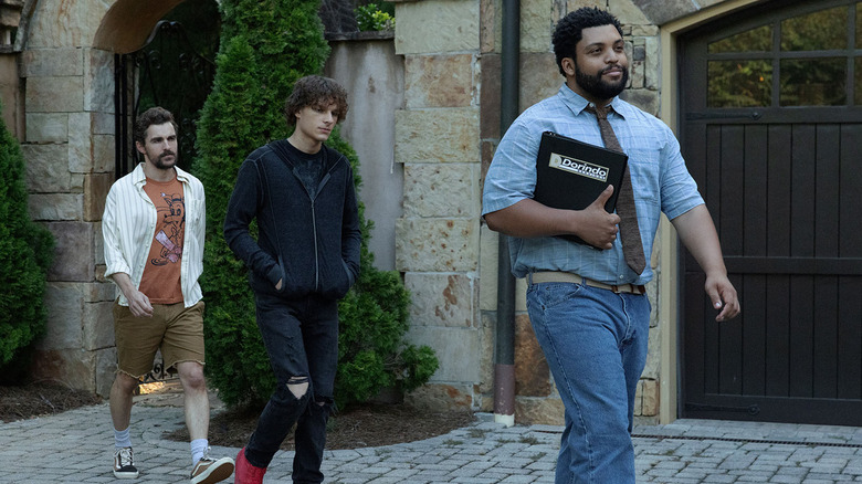 Mark, Sheridan, and Davis walking out of a mansion in Idiots