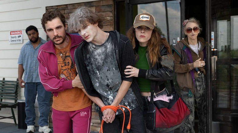 Mark and Irina dragging Sheridan out of a motel in Idiots