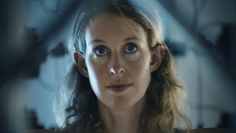 Elizabeth Holmes is bathed in blue lighting in You Can See Everything