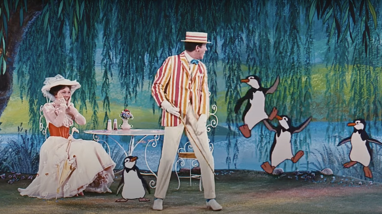 Julie Andrews as Mary Poppins watching Dick Van Dyke as Bert penguins dancing 