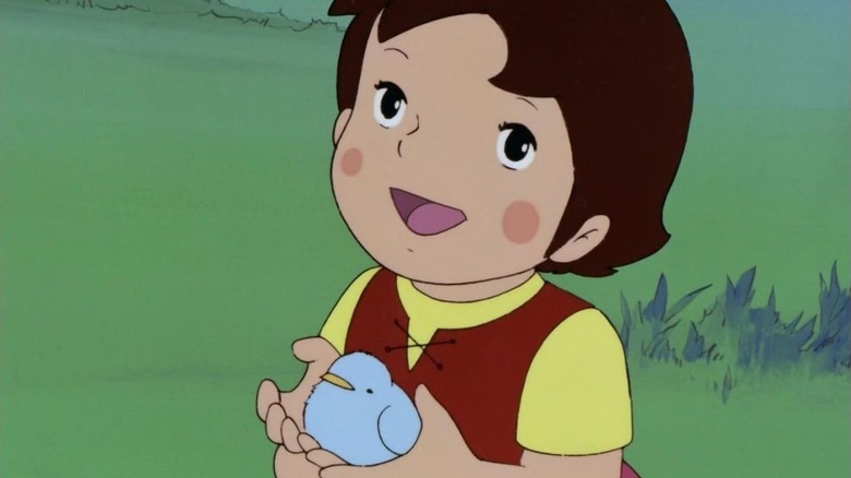 Heidi holds a bird in her hands in Heidi, Girl of the Alps