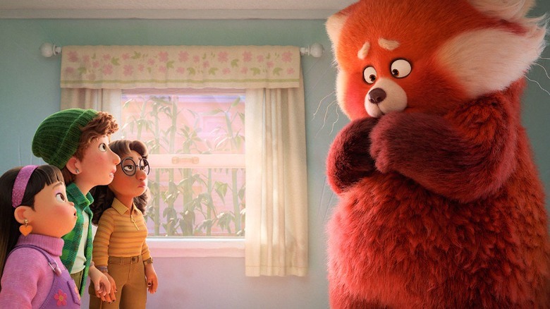 Friends look at red panda