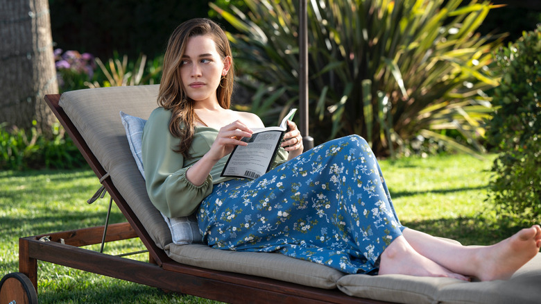 Love Quinn reads a book in a lounge chair in You
