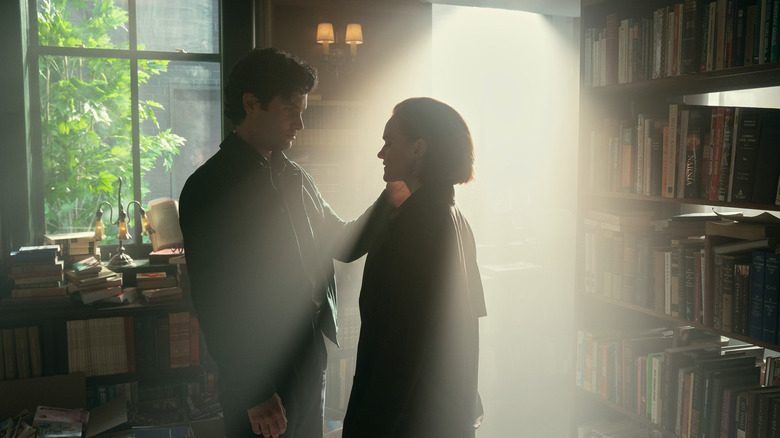 Joe Goldberg touches Bronte,, who stands in a beam of sunlight in a bookstore in You