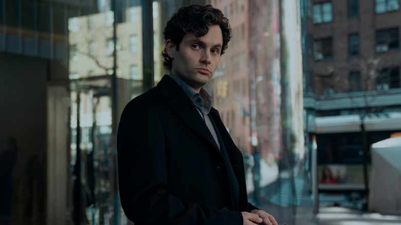 Joe standing outside of a building in You