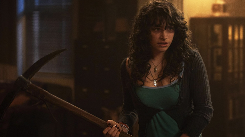 Nina wields a pick axe in Until Dawn