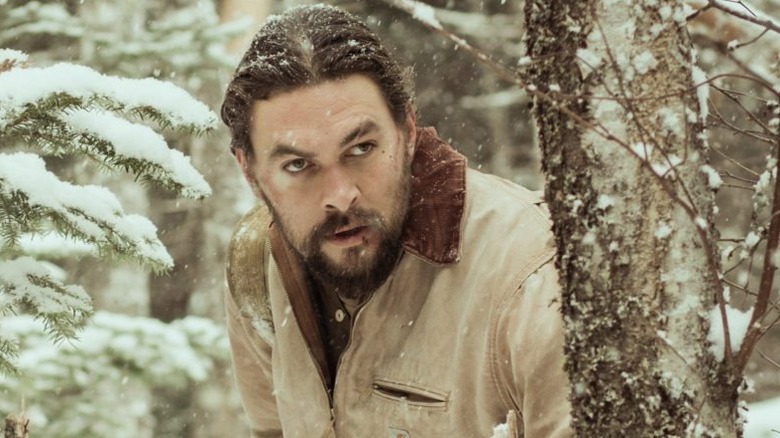 John Braven hiding behind a tree in "Braven"