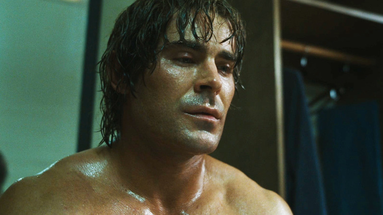 Zac Efron's Kevin Von Erich looks down as he sits drenched in sweat in The Iron Claw