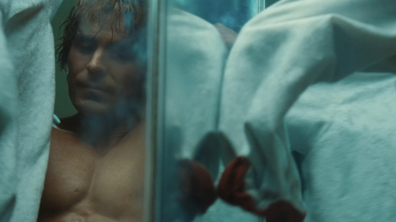 Zac Efron's Kevin Von Erich is seen in a mirror as he gets dressed in The Iron Claw