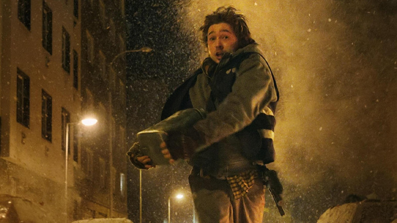 Austin Abrams as Bryan running down the street with the package in Resident Evil (2026)