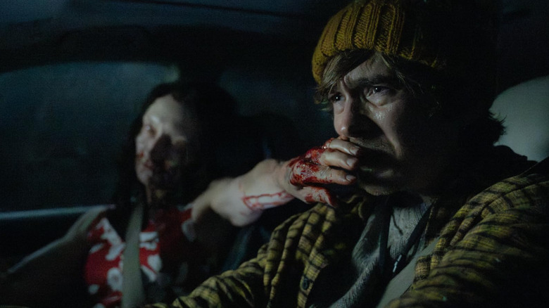 A zombie woman puts her hand on Bryan's face in Resident Evil (2026)