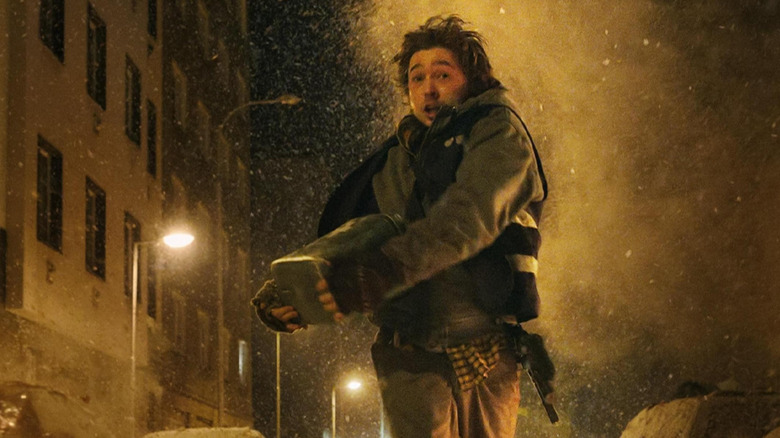 Austin Abrams as Bryan running down the street as bodies explode around him in Resident Evil (2026)