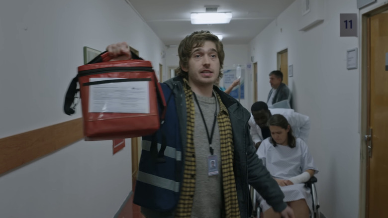 Bryan holds up a organ transplant bag in a hospital in Resident Evil