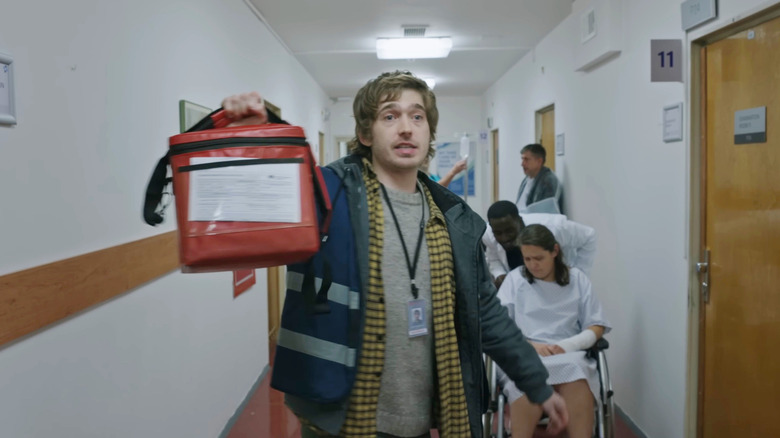 Bryan holds up a organ transplant bag in a hospital in Resident Evil