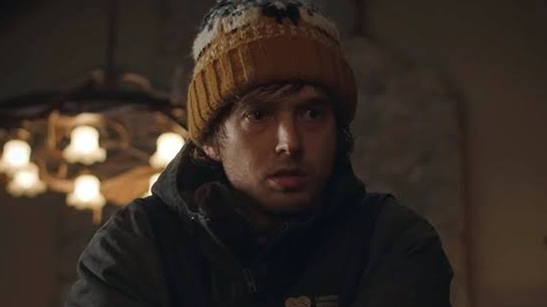 Austin Abrams as Bryan walking through the house in his beanie in Resident Evil (2026)
